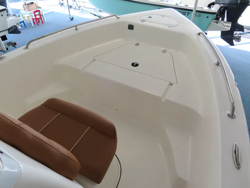 Slide: The Image of 2025 Key West 179 FS boat interior with brown seating and storage compartment. - 12