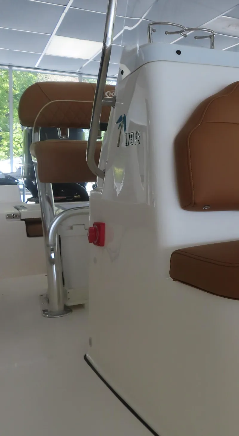 Slide: The Image of 2025 Key West 179 FS boat interior with brown seating and modern design. - 15