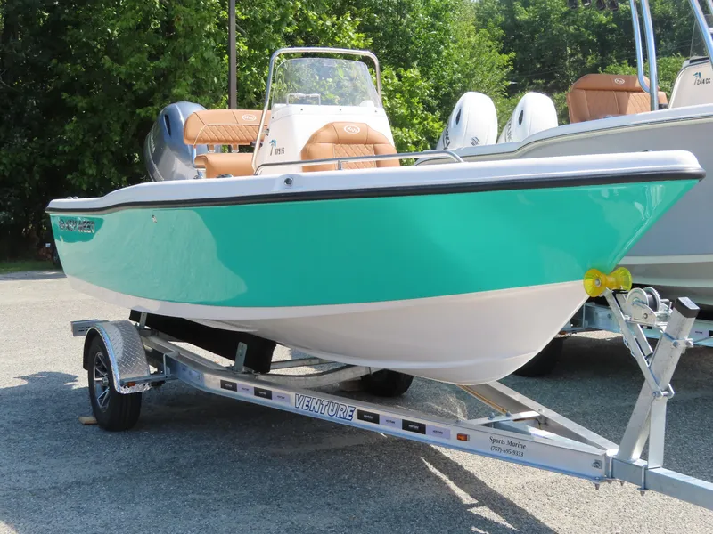 Slide: The Image of 2025 Key West 179 FS boat on trailer, turquoise hull, parked outdoors. - 5