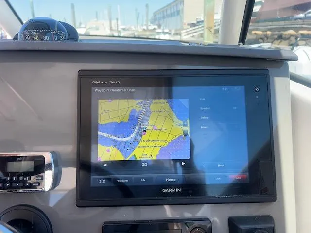 Slide: The Image of Garmin GPS display on 2017 Pursuit DC 325 Dual Console boat dashboard. - 12