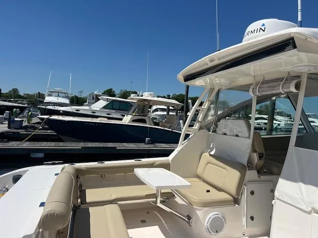Slide: The Image of 2017 Pursuit DC 325 Dual Console boat docked at marina under clear blue sky. - 14