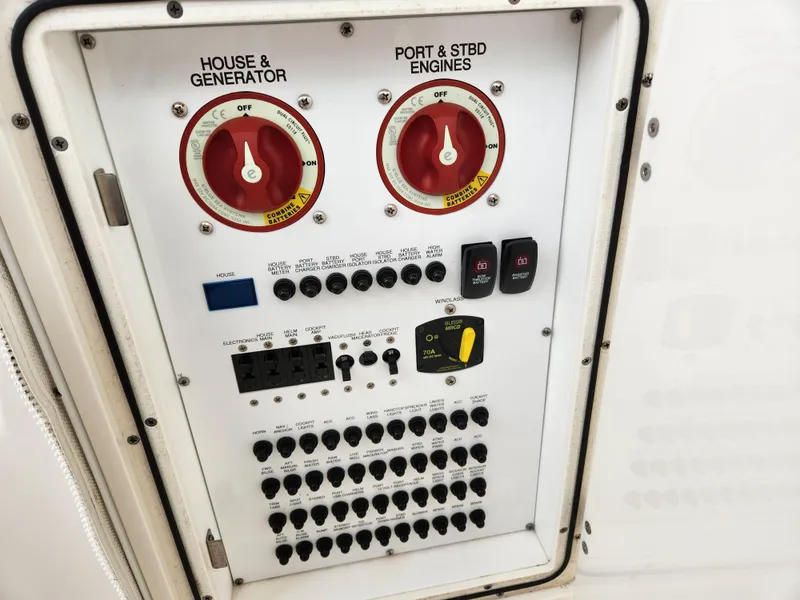 Slide: The Image of Electrical panel of 2017 Pursuit DC 325 Dual Console boat with switches and controls. - 7