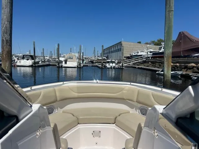 Slide: The Image of 2017 Pursuit DC 325 Dual Console boat docked at a marina under clear blue skies. - 9