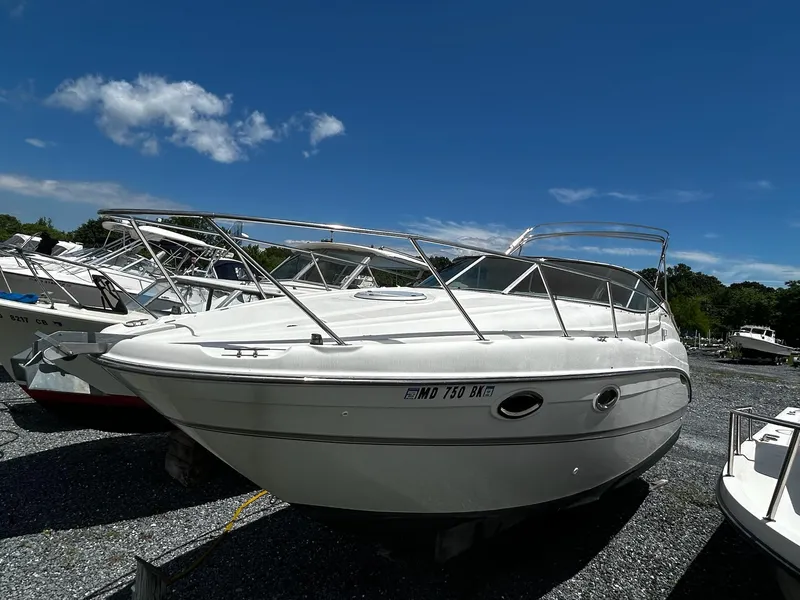 Slide: The Image of 2000 Maxum 2800 SCR boat interior with white seating and outdoor storage area. - 9