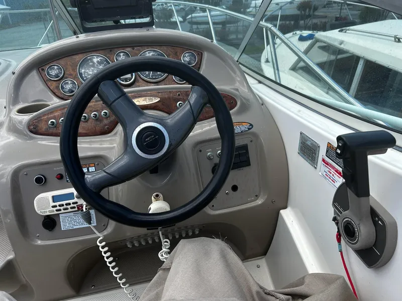 Slide: The Image of Steering wheel and controls of a 2000 Maxum 2800 SCR boat. - 11