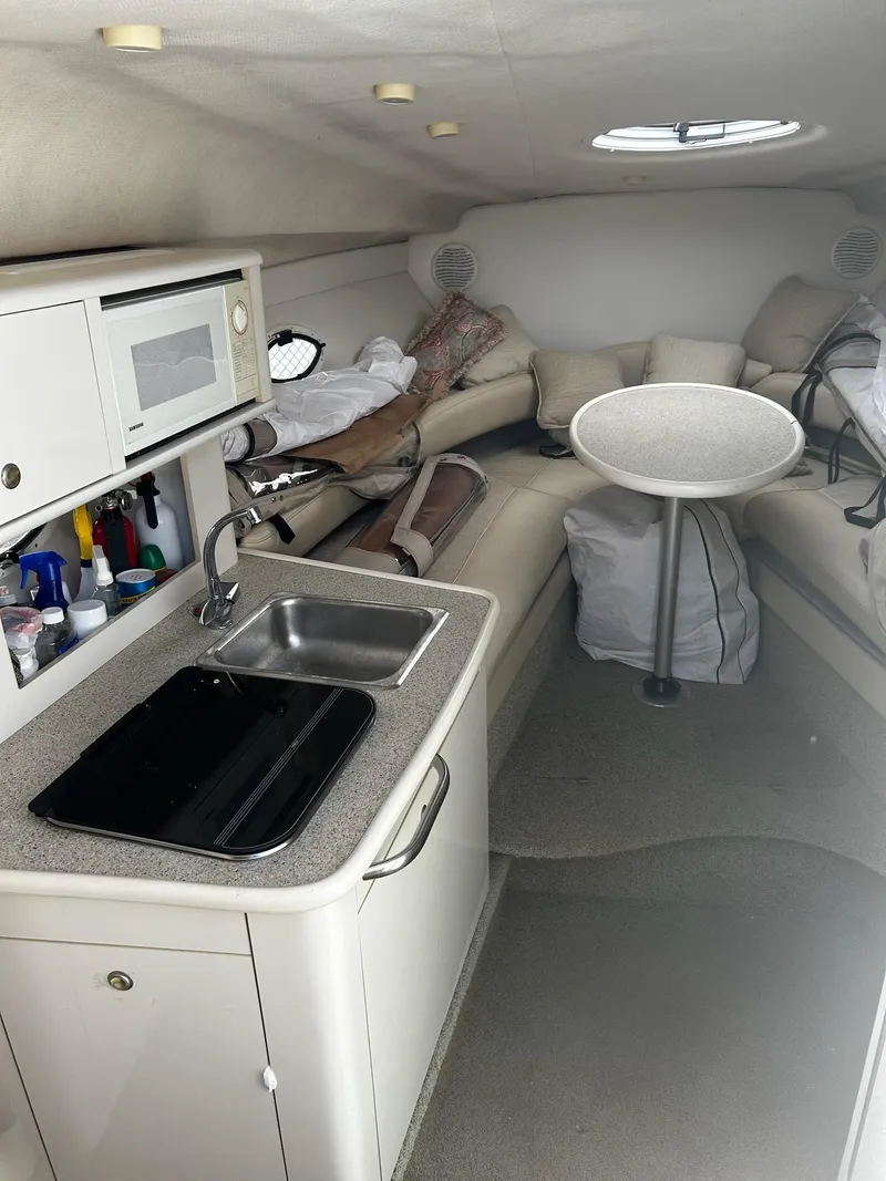 Slide: The Image of Interior of 2000 Maxum 2800 SCR boat with kitchenette and seating area. - 15