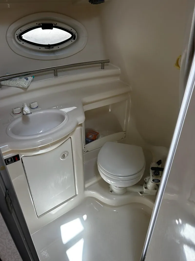 Slide: The Image of Compact bathroom in 2000 Maxum 2800 SCR boat with sink and toilet. - 16