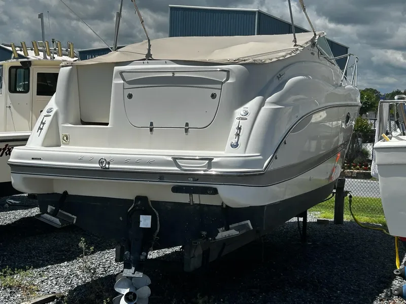 Slide: The Image of 2000 Maxum 2800 SCR boat on display, rear view, outdoors, under cloudy sky. - 5