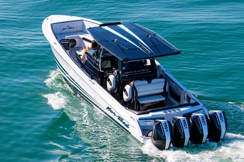 Slide: The Image of 2026 Nor-Tech 400 Supersport boat cruising on clear blue water. - 1