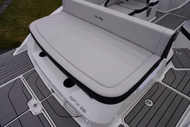 Slide: The Image of 2024 Sea Ray SPX 210 boat with sleek white seating and modern deck design. - 12
