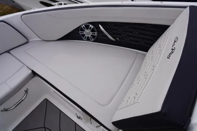 Slide: The Image of 2024 Sea Ray SPX 210 boat interior with white seating and speaker detail. - 16