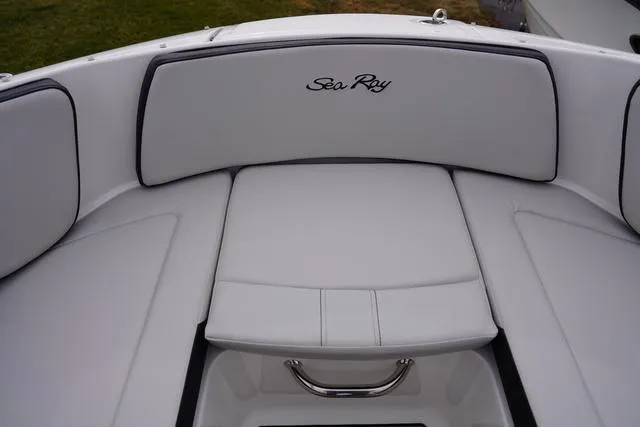 Slide: The Image of 2024 Sea Ray SPX 210 boat interior with white cushioned seating. - 17