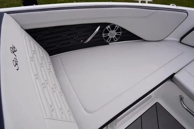 Slide: The Image of 2024 Sea Ray SPX 210 boat interior with white seating and speaker detail. - 18
