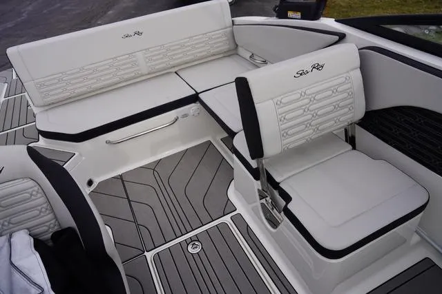 Slide: The Image of 2024 Sea Ray SPX 210 boat interior with white seating and modern design. - 19