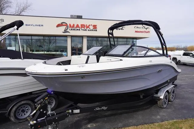 Slide: The Image of 2024 Sea Ray SPX 210 boat on trailer outside Mark's Leisure Time Marine dealership. - 2