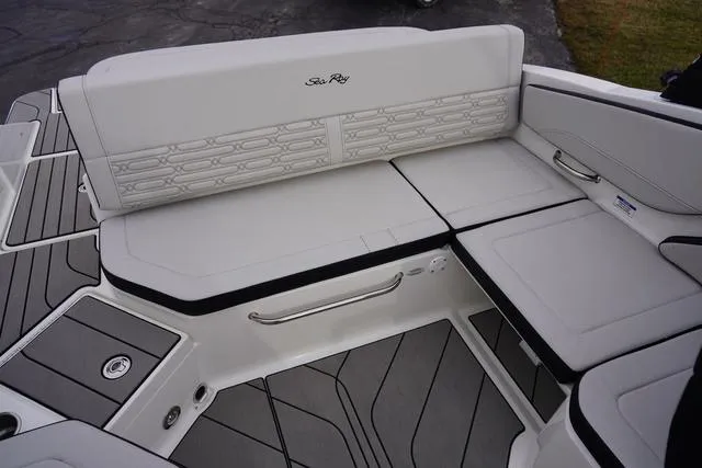 Slide: The Image of 2024 Sea Ray SPX 210 boat interior with white cushioned seating and sleek design. - 20
