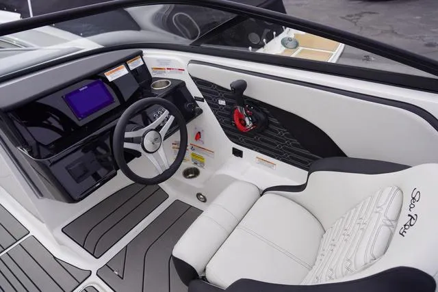 Slide: The Image of 2024 Sea Ray SPX 210 boat interior with modern dashboard and steering wheel. - 21