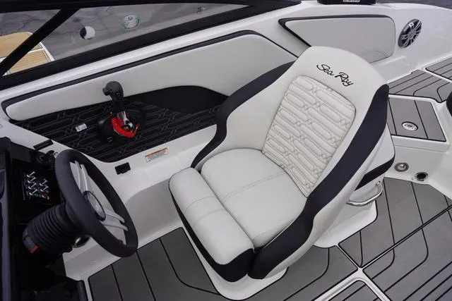 Slide: The Image of 2024 Sea Ray SPX 210 boat interior with white captain's seat and steering wheel. - 22