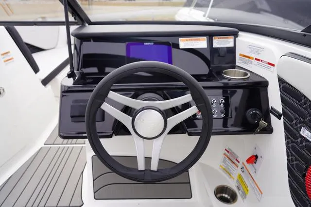 Slide: The Image of 2024 Sea Ray SPX 210 boat dashboard with steering wheel and control panel. - 24