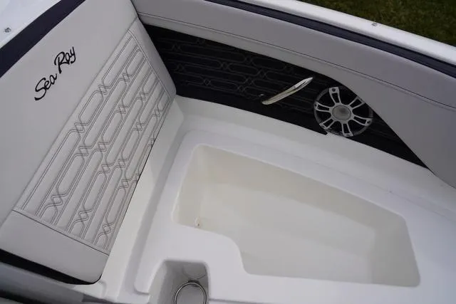 Slide: The Image of 2024 Sea Ray SPX 210 boat interior with stylish seating and speaker detail. - 32