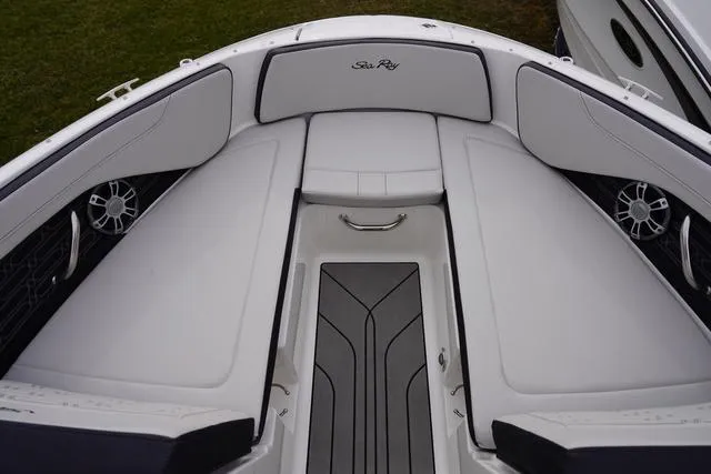 Slide: The Image of 2024 Sea Ray SPX 210 boat interior with cushioned seating and sleek design. - 33