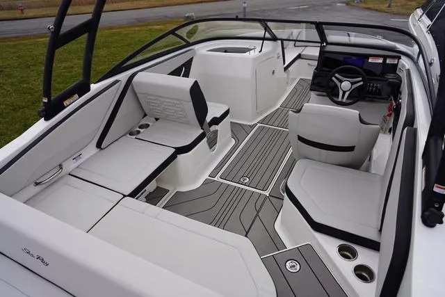 Slide: The Image of 2024 Sea Ray SPX 210 boat interior with sleek seating and modern dashboard design. - 34
