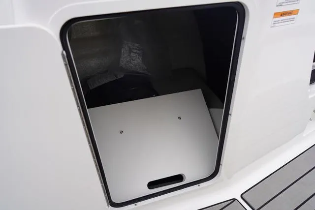 Slide: The Image of 2024 Sea Ray SPX 210 storage compartment with open hatch, showcasing interior space. - 38