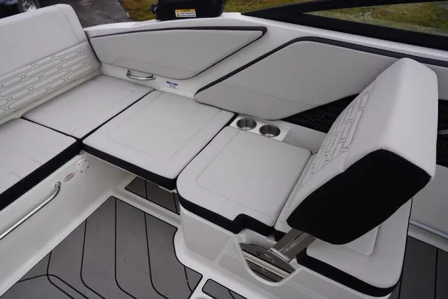 Slide: The Image of 2024 Sea Ray SPX 210 boat interior with white seating and cup holders. - 39