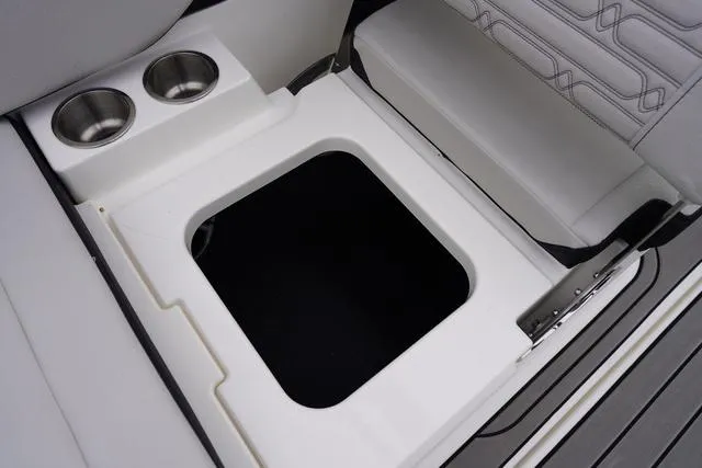 Slide: The Image of 2024 Sea Ray SPX 210 boat interior with storage compartment and cup holders. - 40