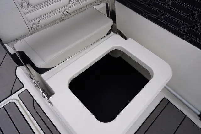 Slide: The Image of 2024 Sea Ray SPX 210 boat seat storage compartment, open with visible interior. - 41