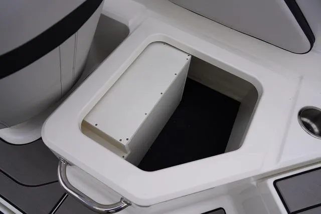 Slide: The Image of 2024 Sea Ray SPX 210 boat storage compartment with handle and cup holder. - 43