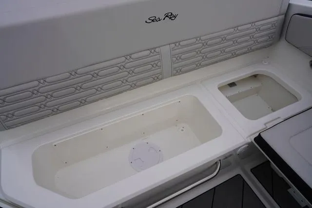 Slide: The Image of 2024 Sea Ray SPX 210 boat interior with storage compartments and sleek design. - 46