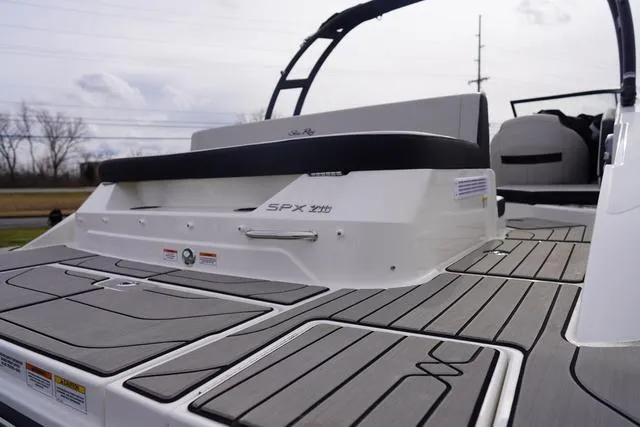 Slide: The Image of 2024 Sea Ray SPX 210 boat with sleek deck design and modern seating. - 7