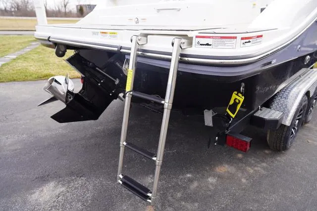 Slide: The Image of 2024 Sea Ray SPX 210 boat with ladder and trailer, rear view. - 8
