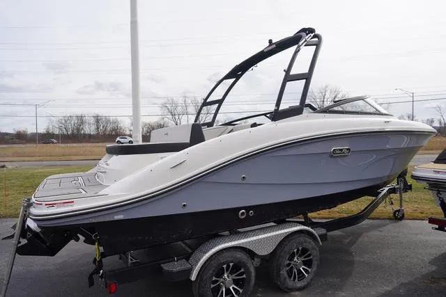 Slide: The Image of 2024 Sea Ray SPX 210 boat on trailer, sleek design, parked outdoors. - 9