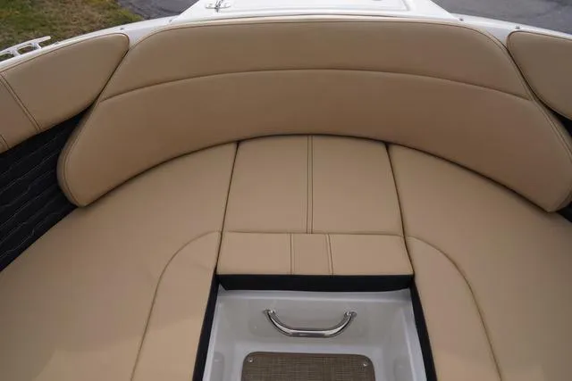 Slide: The Image of 2024 Sea Ray SPX 230 boat interior with tan cushioned seating. - 10