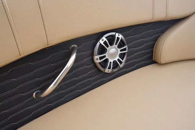 Slide: The Image of 2024 Sea Ray SPX 230 interior detail with speaker and handle on beige upholstery. - 12