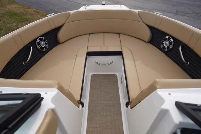 Slide: The Image of 2024 Sea Ray SPX 230 boat interior with tan seating and modern design. - 13