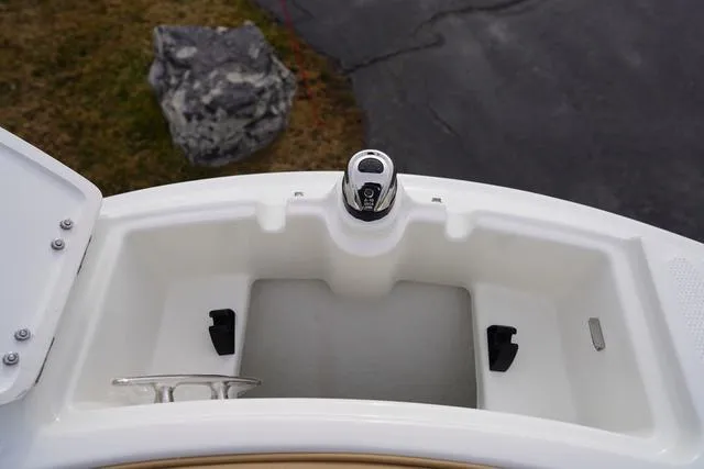 Slide: The Image of 2024 Sea Ray SPX 230 boat storage compartment with cup holder and latch. - 14