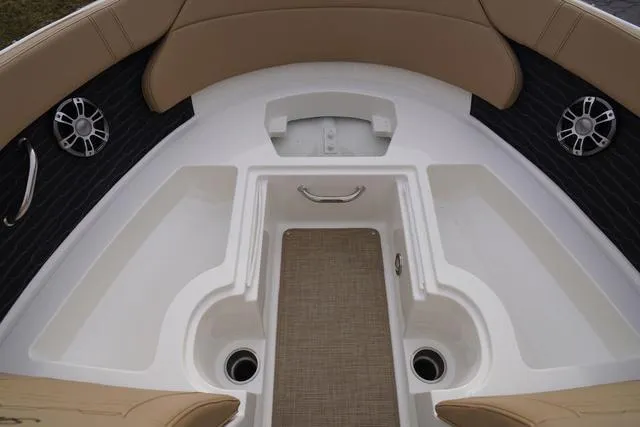 Slide: The Image of 2024 Sea Ray SPX 230 boat interior with tan seating and modern design. - 15