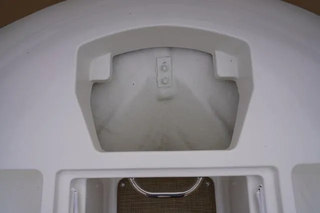 Slide: The Image of 2024 Sea Ray SPX 230 boat storage compartment, white interior, close-up view. - 17