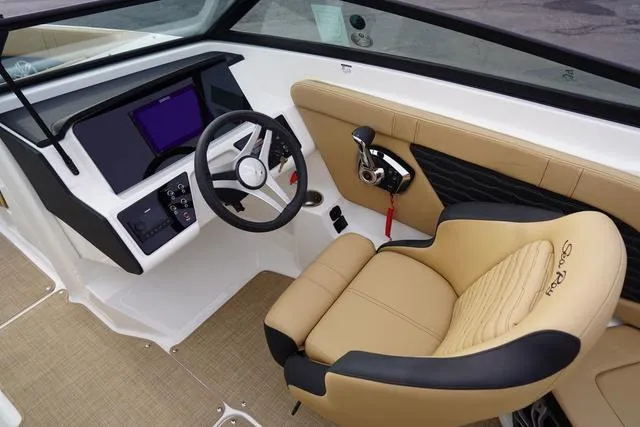 Slide: The Image of 2024 Sea Ray SPX 230 boat interior with tan seating and modern dashboard. - 19