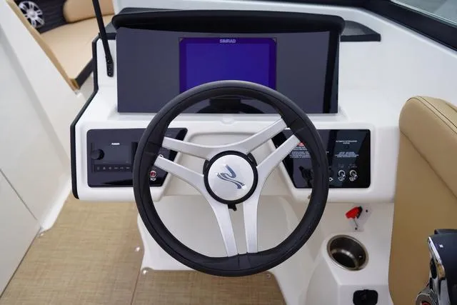 Slide: The Image of 2024 Sea Ray SPX 230 dashboard with steering wheel and control panel. - 22