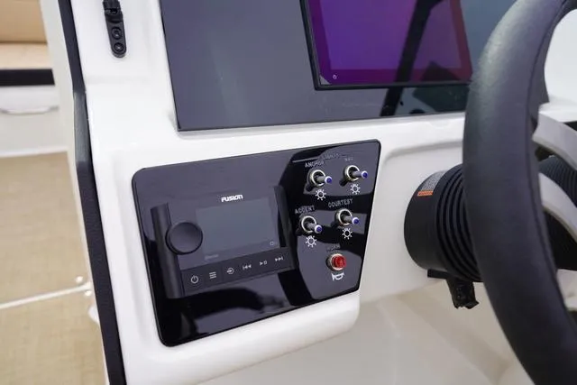 Slide: The Image of 2024 Sea Ray SPX 230 dashboard with control panel and steering wheel. - 23