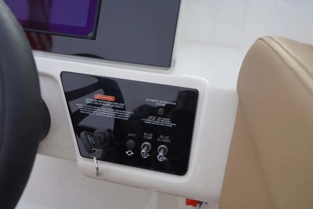 Slide: The Image of Control panel of 2024 Sea Ray SPX 230 boat with ignition and switches. - 25