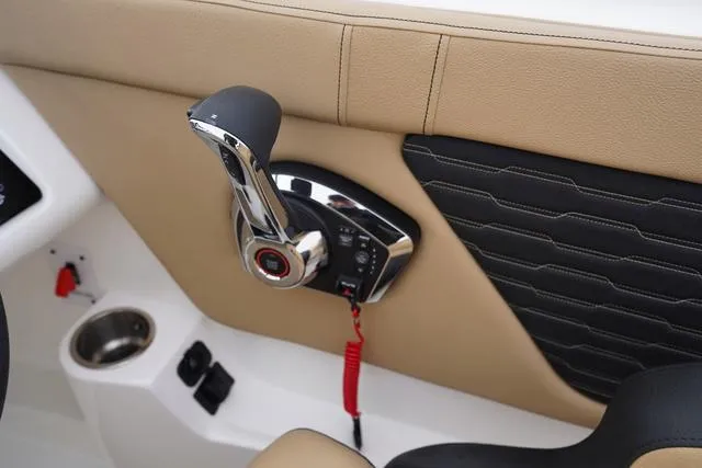 Slide: The Image of 2024 Sea Ray SPX 230 throttle control with beige and black interior accents. - 26