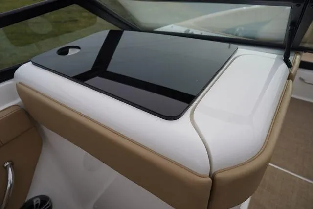 Slide: The Image of 2024 Sea Ray SPX 230 boat dashboard with sleek black panel and tan accents. - 27
