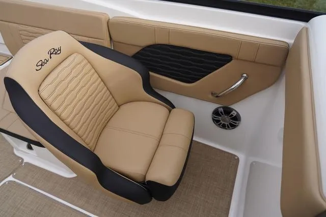 Slide: The Image of 2024 Sea Ray SPX 230 boat interior with tan and black seating, speaker, and handle. - 28
