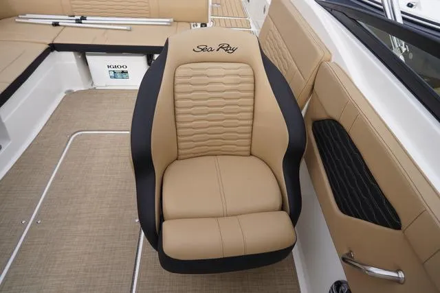 Slide: The Image of 2024 Sea Ray SPX 230 boat interior with tan and black seating. - 30