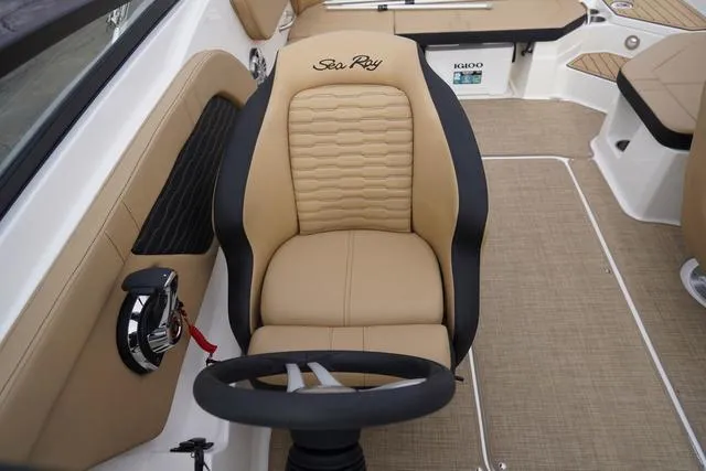 Slide: The Image of 2024 Sea Ray SPX 230 boat interior with tan seating and steering wheel. - 31